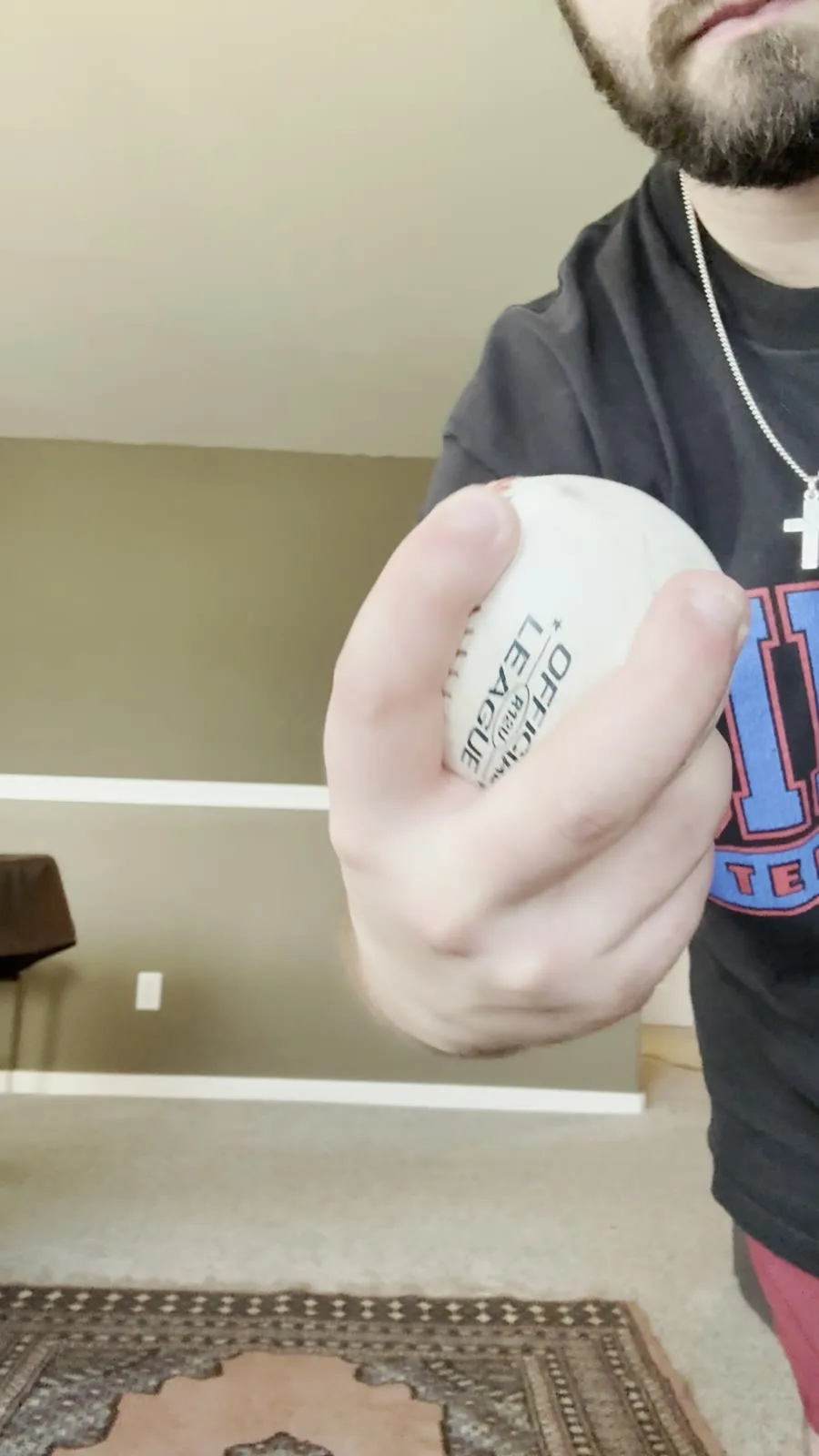 A looping close-up of Austin's two-seam grip: two fingers running along the narrow seams like train tracks.